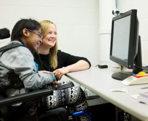 Kiki using assistive technology during therapy.