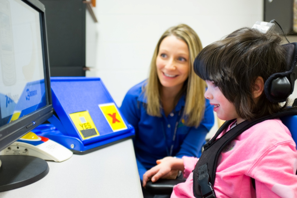 Child using augmentative communication device